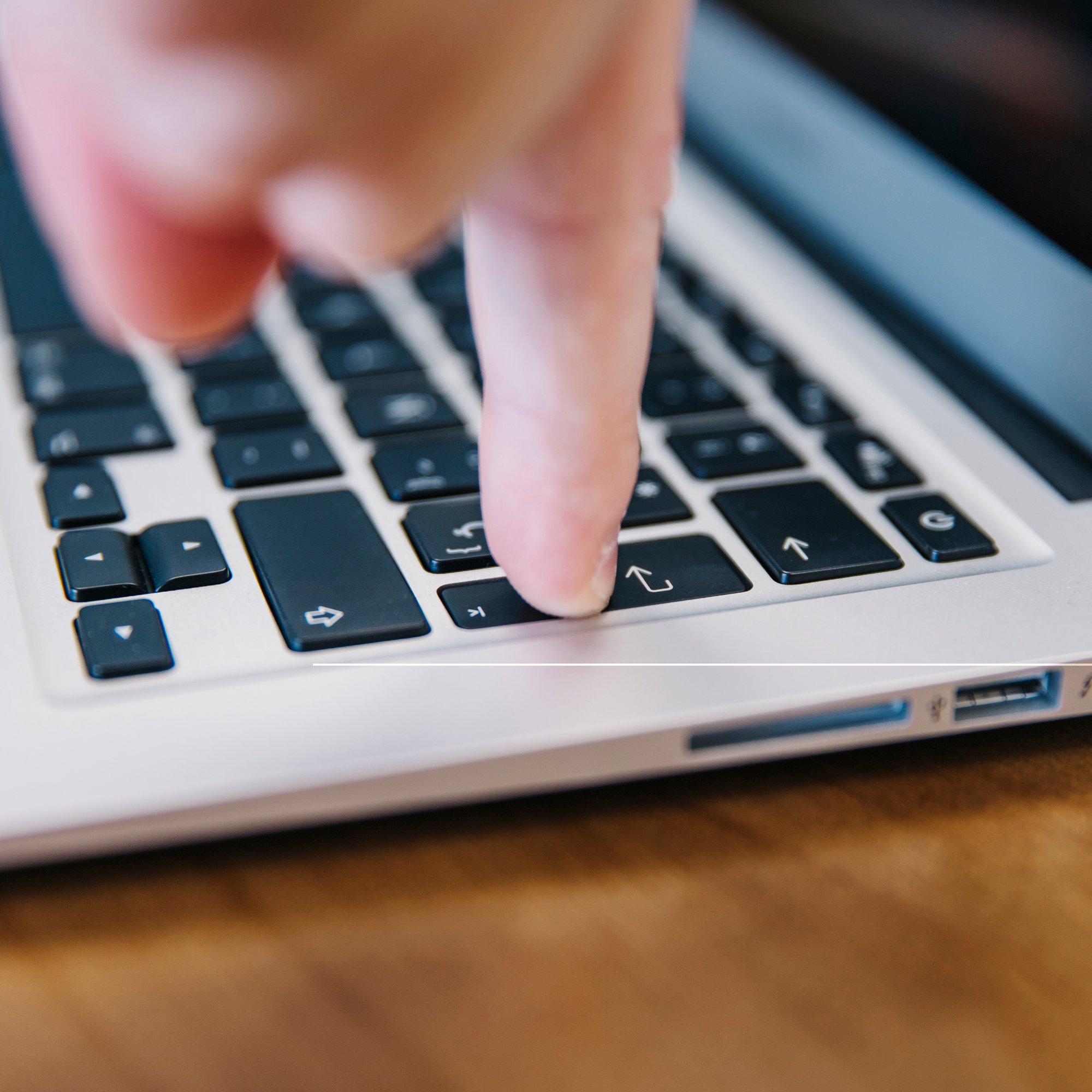 close-up-finger-pressing-keyboard-button